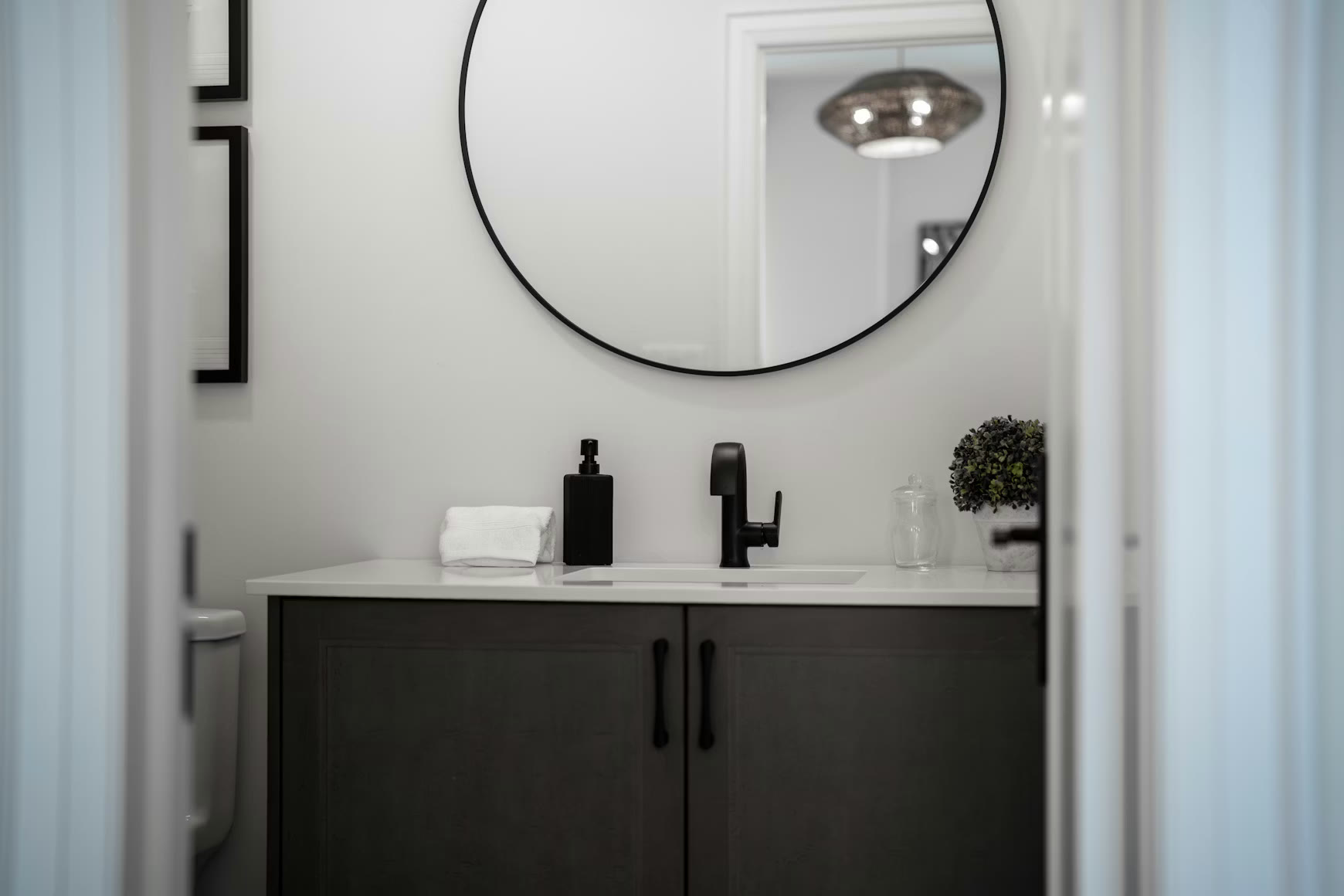 Powder room renovation with statement wallpaper and floating vanity
